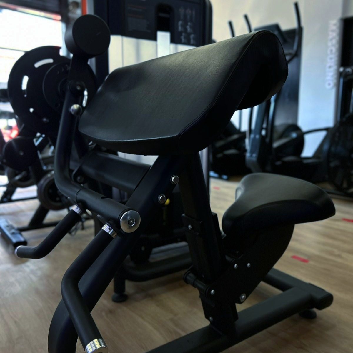 Equipamento de musculação sobre piso de madeira